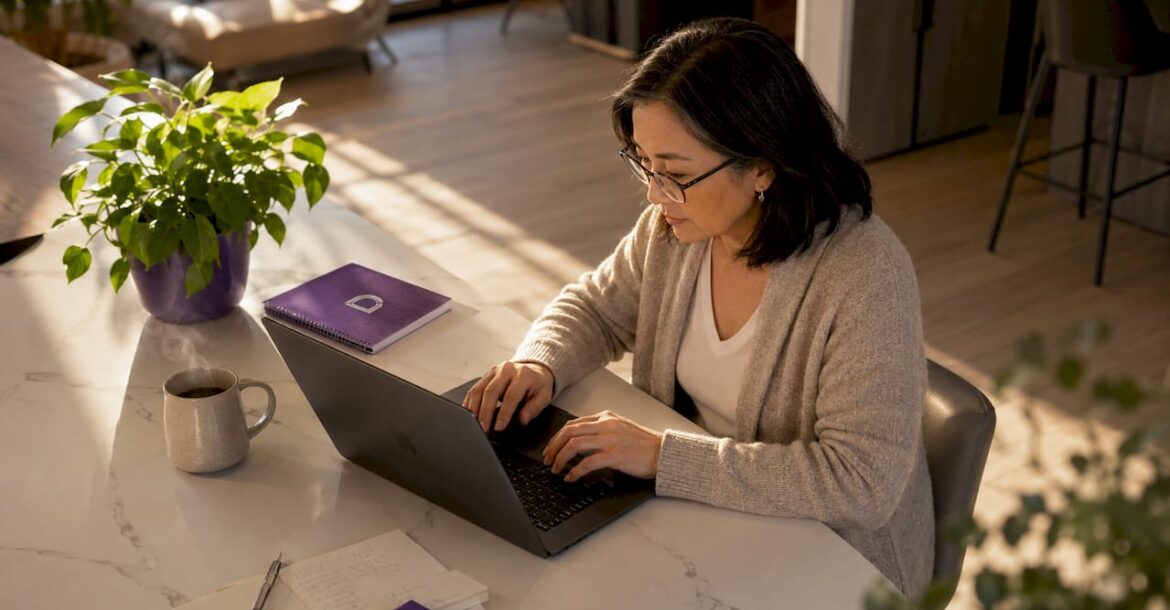 Woman typing on laptop in home office