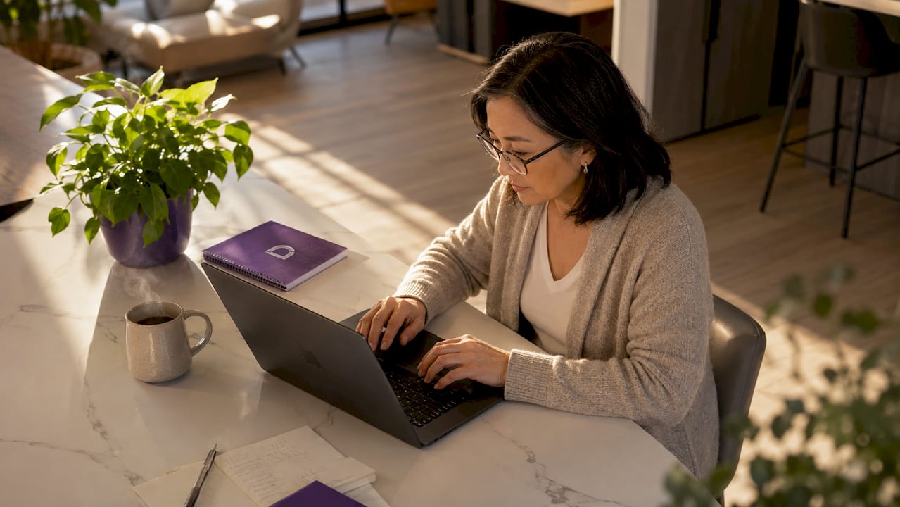 Woman typing on laptop in home office