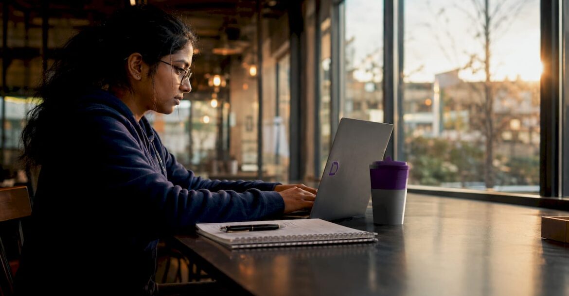 Woman working on containerised web hosting laptop setup